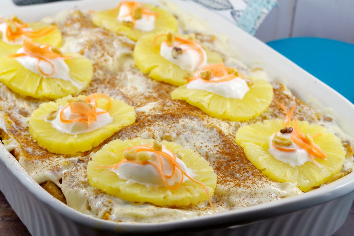 Whole Carrot Cake French Toast Casserole with pineapples dotted with whipped cream and grated carrots on top