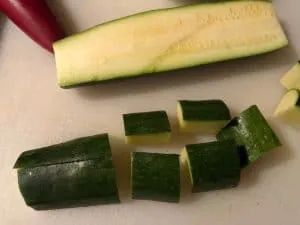 Zucchini being cut into pieces for skewer