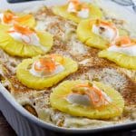 Whole Carrot Cake French Toast Casserole with pineapples dotted with whipped cream and grated carrots on top