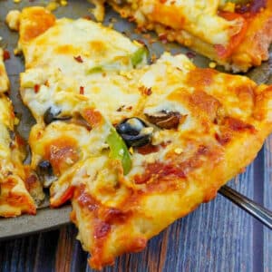 slice of weight watchers pizza being lifted off a pizza pan