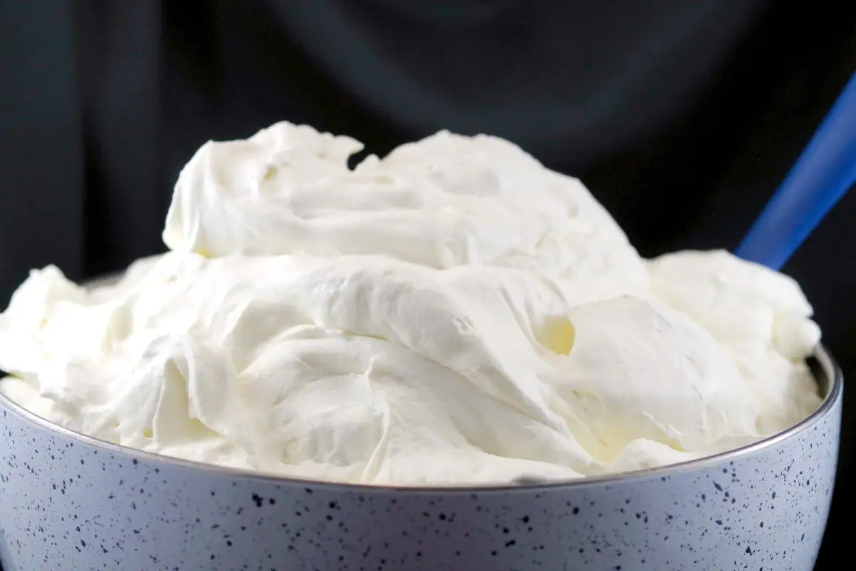 top of speckled bowl of white whipped cream frosting