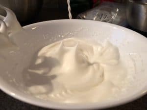 egg whites beaten to stiff peaks in white bowl
