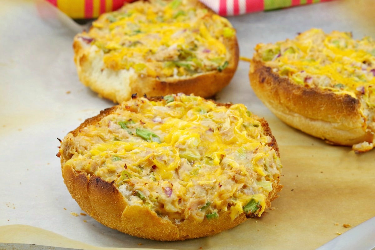 Open faced tuna melts on parchment paper covered baking sheet