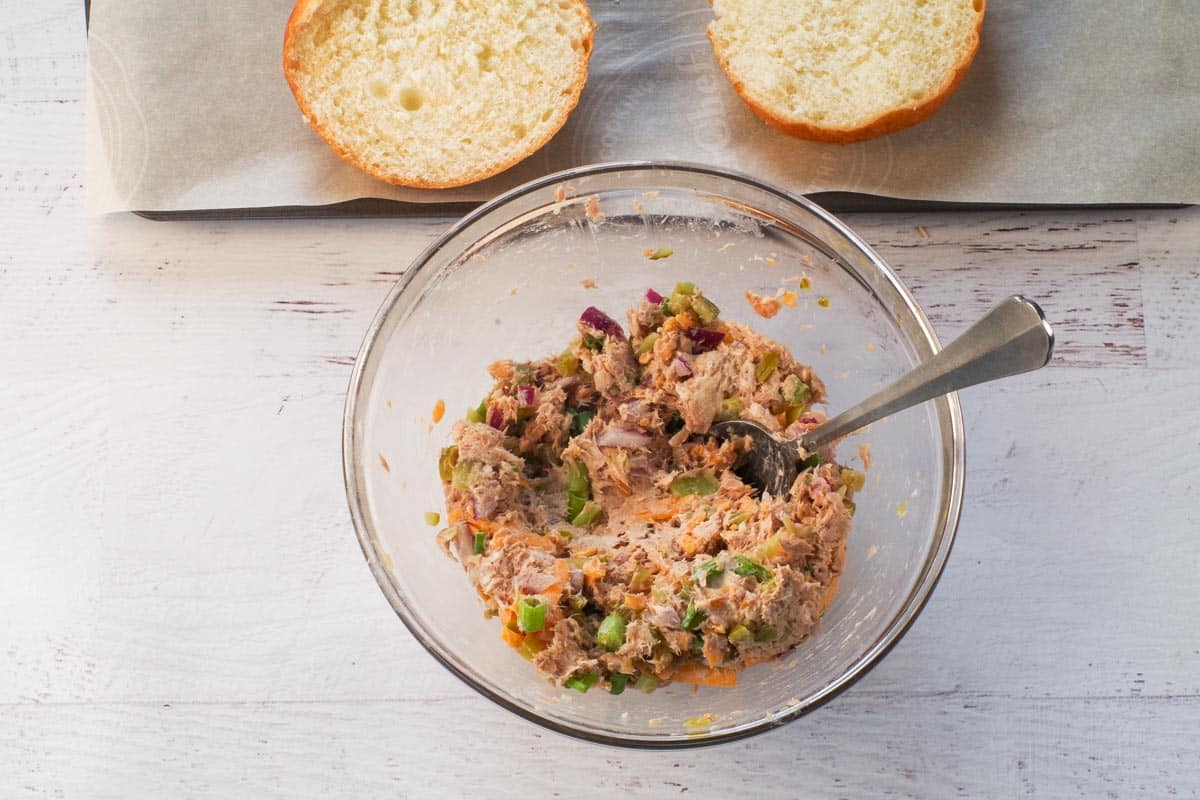  ingredients in tuna melts mixed together in medium glass bowl with a spoon