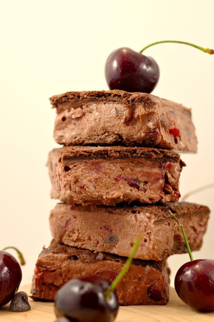 Black forest ice cream sandwiches stacked , with cherries