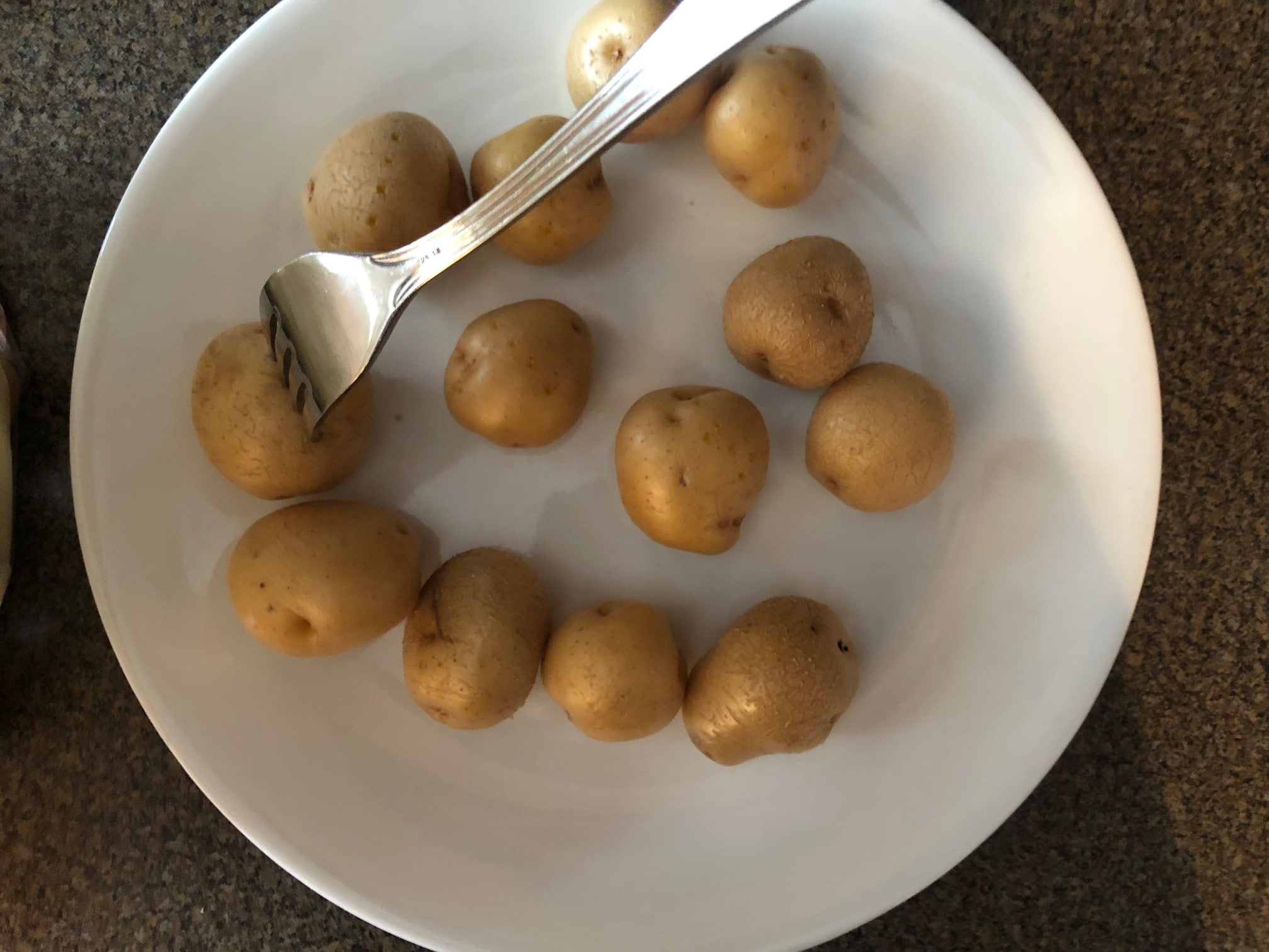 creamer potatoes being poked with a fork