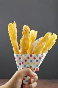 Churros in carnival style colored polka dot paper holder