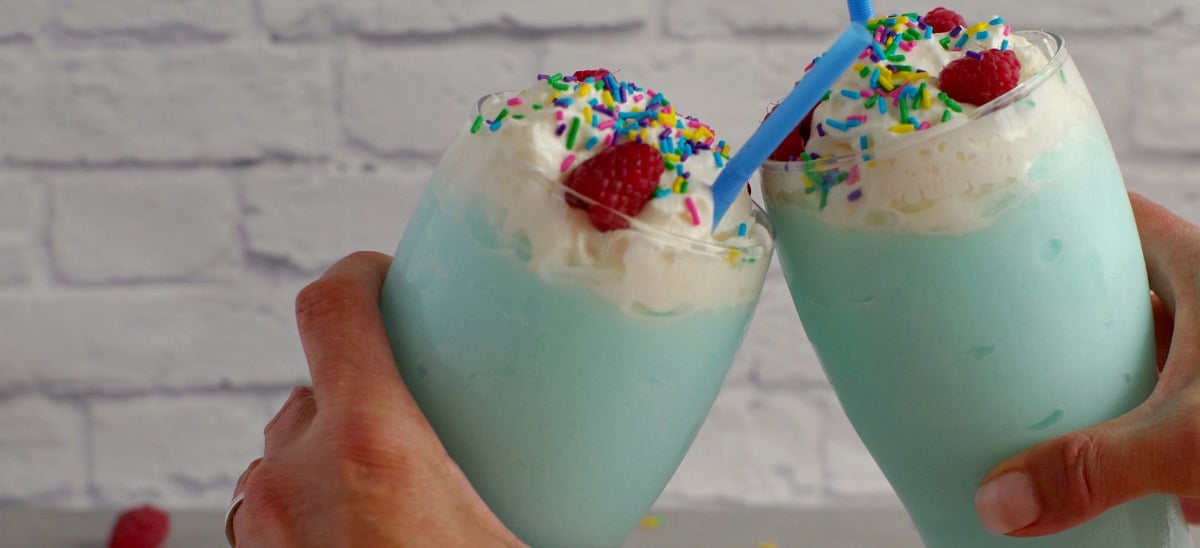 2 blue raspberry non alcoholic drinks being clinked together