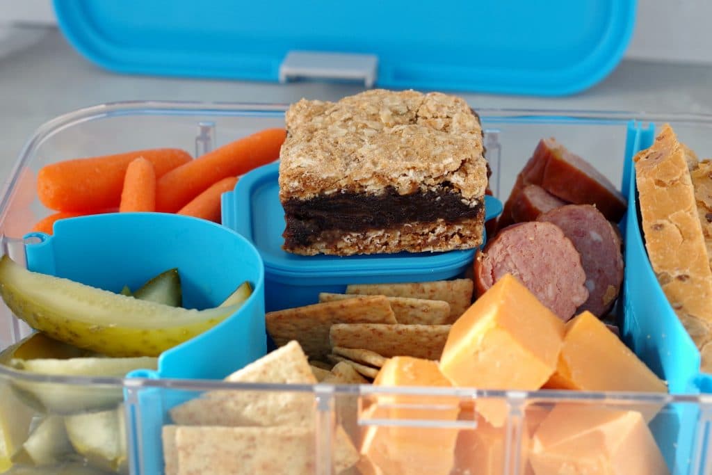 Filled Ukrainian Bento box with date square and bento box lid in background