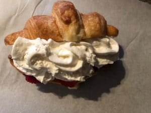 whipped cream added to strawberry tiramisu croissant