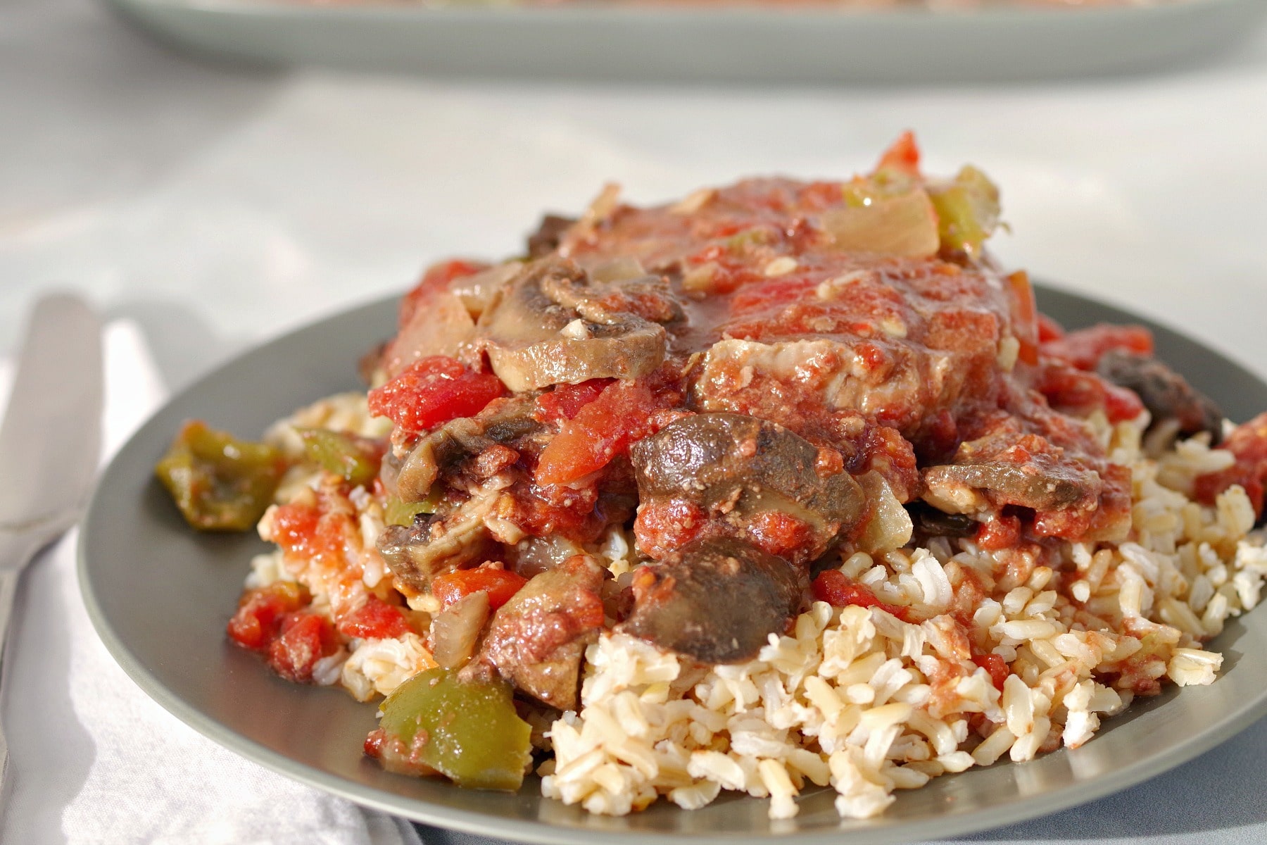 Slow Cooker Swiss Steak on Rice (on green plate)