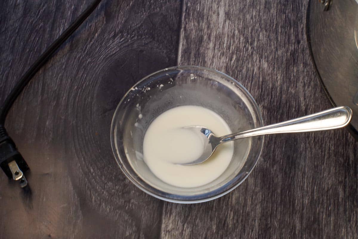 cornstarch mixed with cold water to make a slurry in a small glass bowl