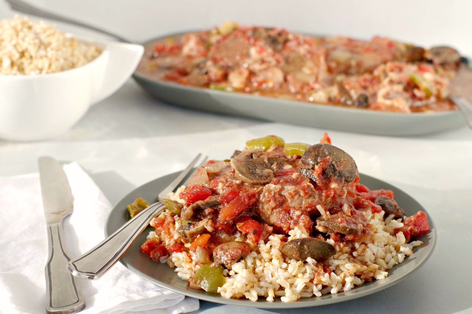 Slow Cooker Swiss Steak on Rice (on green plate)