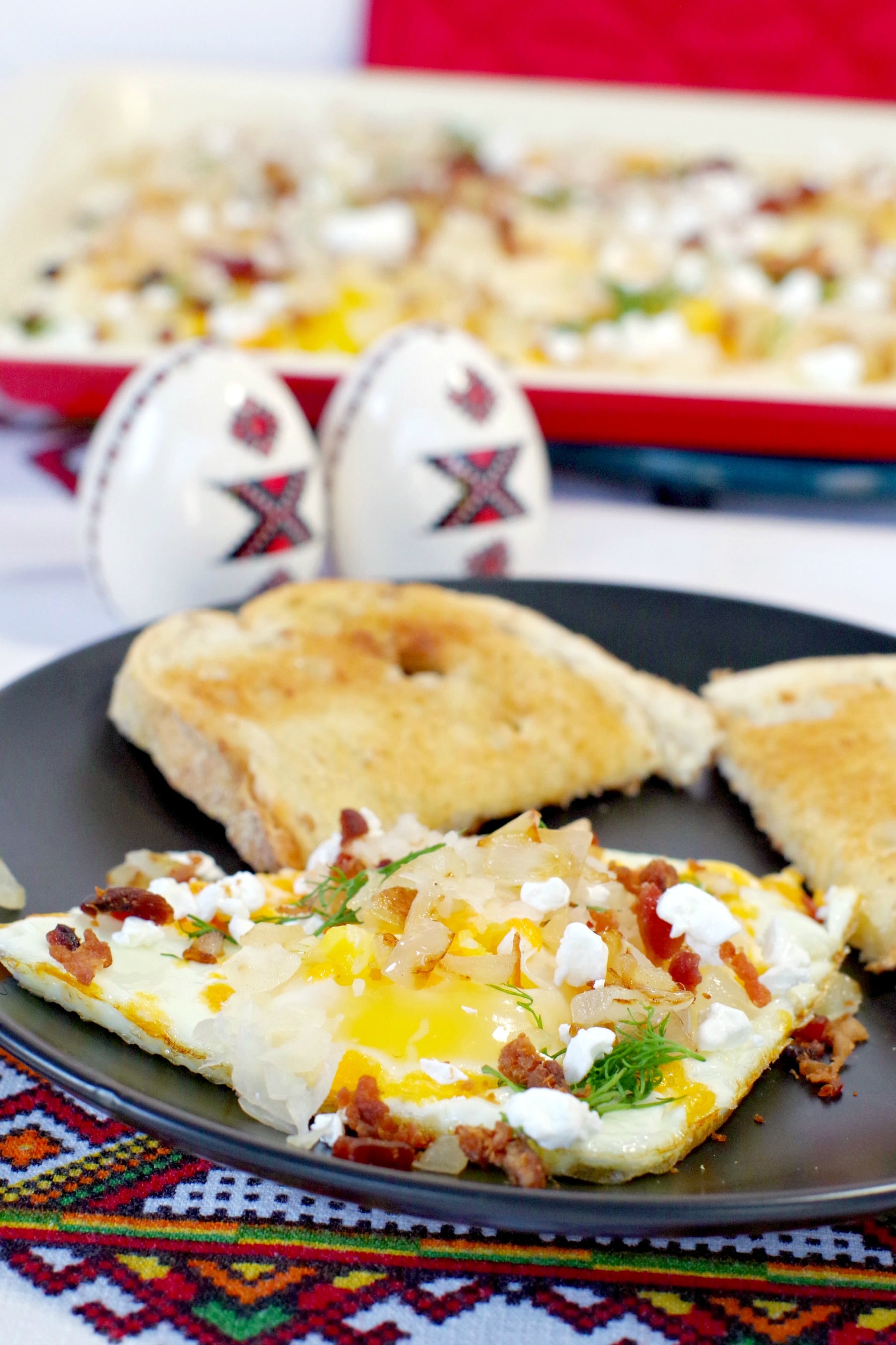 Sheet pan Ukrainian style eggs on plate with eggs on sheet pan in background