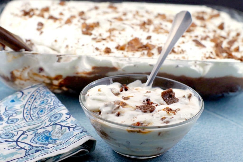 Bowl of Skor Bar Dessert in front and pan of Skor Bar dessert in background