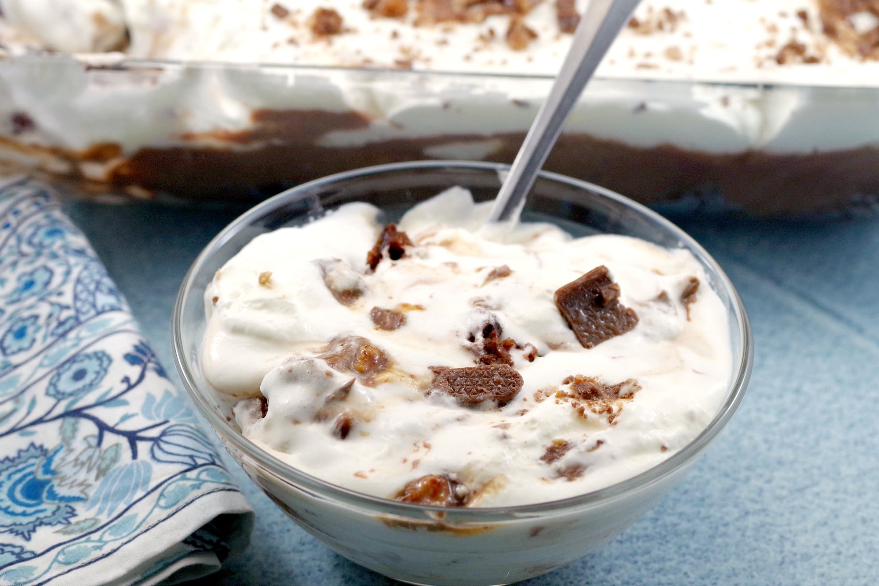 Bowl of Skor Bar Dessert in front and pan of Skor Bar dessert in background