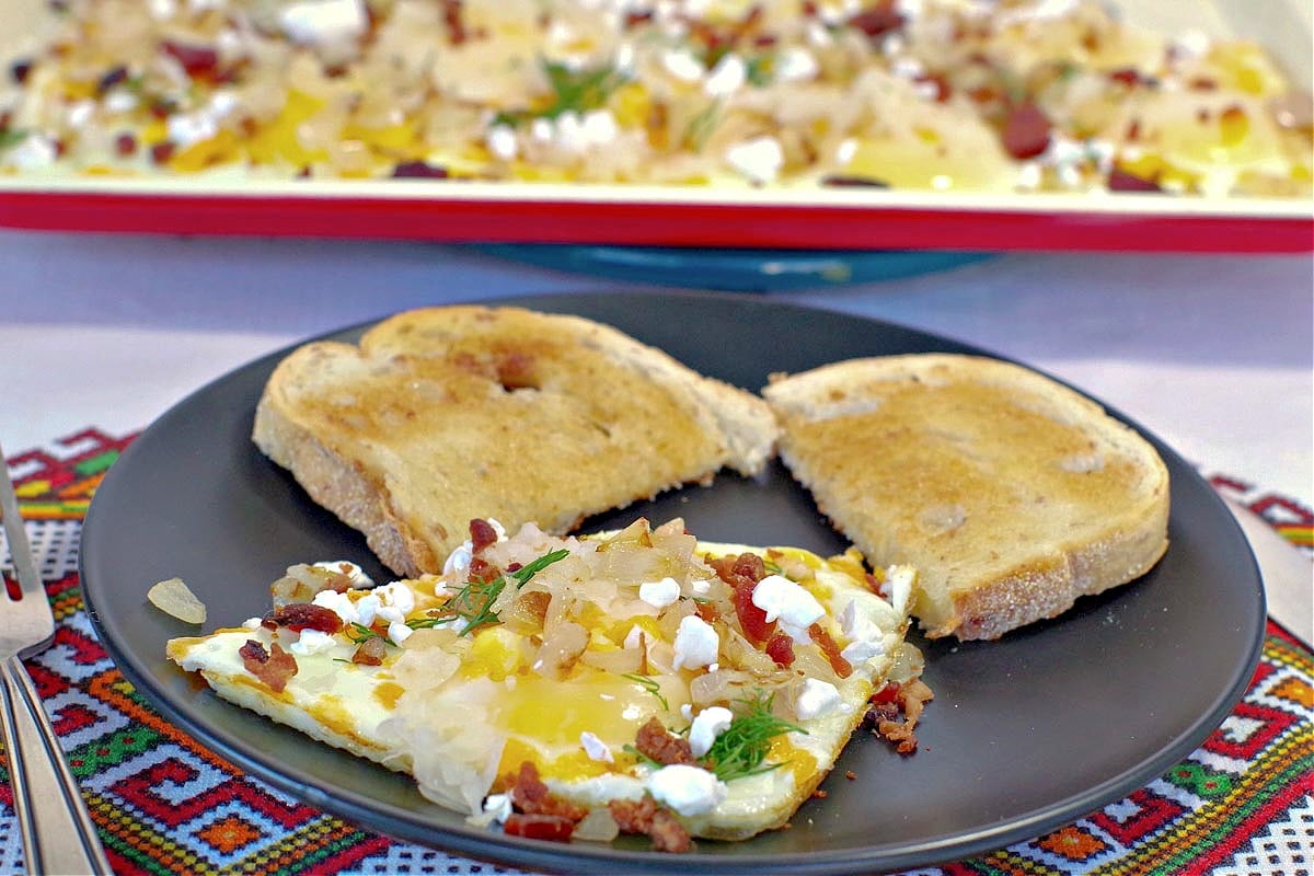 Sheet pan Ukrainian style eggs on plate with eggs on sheet pan in background