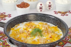 Ukrainian style eggs in foreground with toppings in background