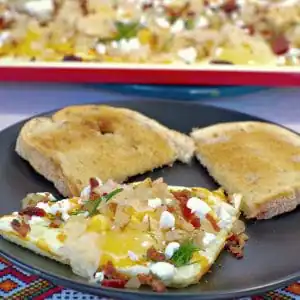 Sheet pan Ukrainian style eggs on plate with eggs on sheet pan in background