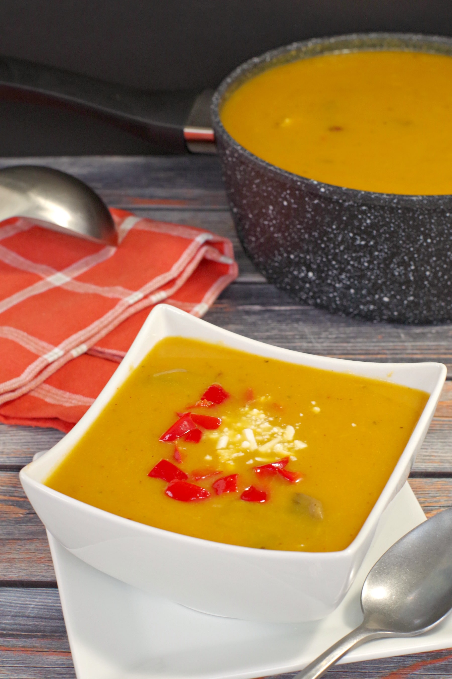 Pumpkin soup in white bowl