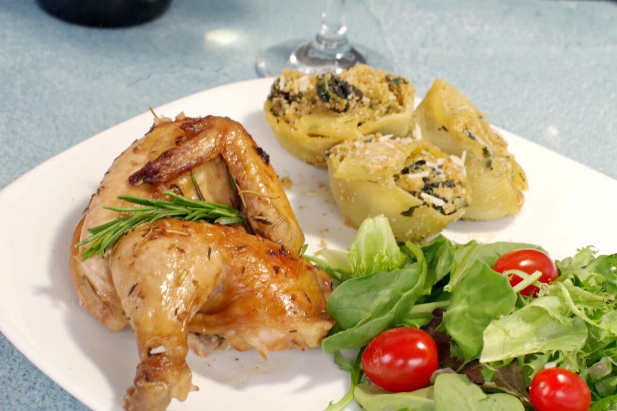 Cornish Hen on a plate with pasta and salad