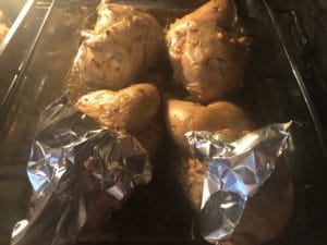 Cornish hens in rosemary wine sauce with legs covered in tin foil