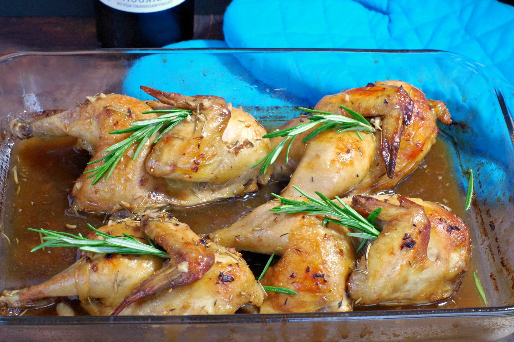 Cornish hens with wine sauce in glass baking dish