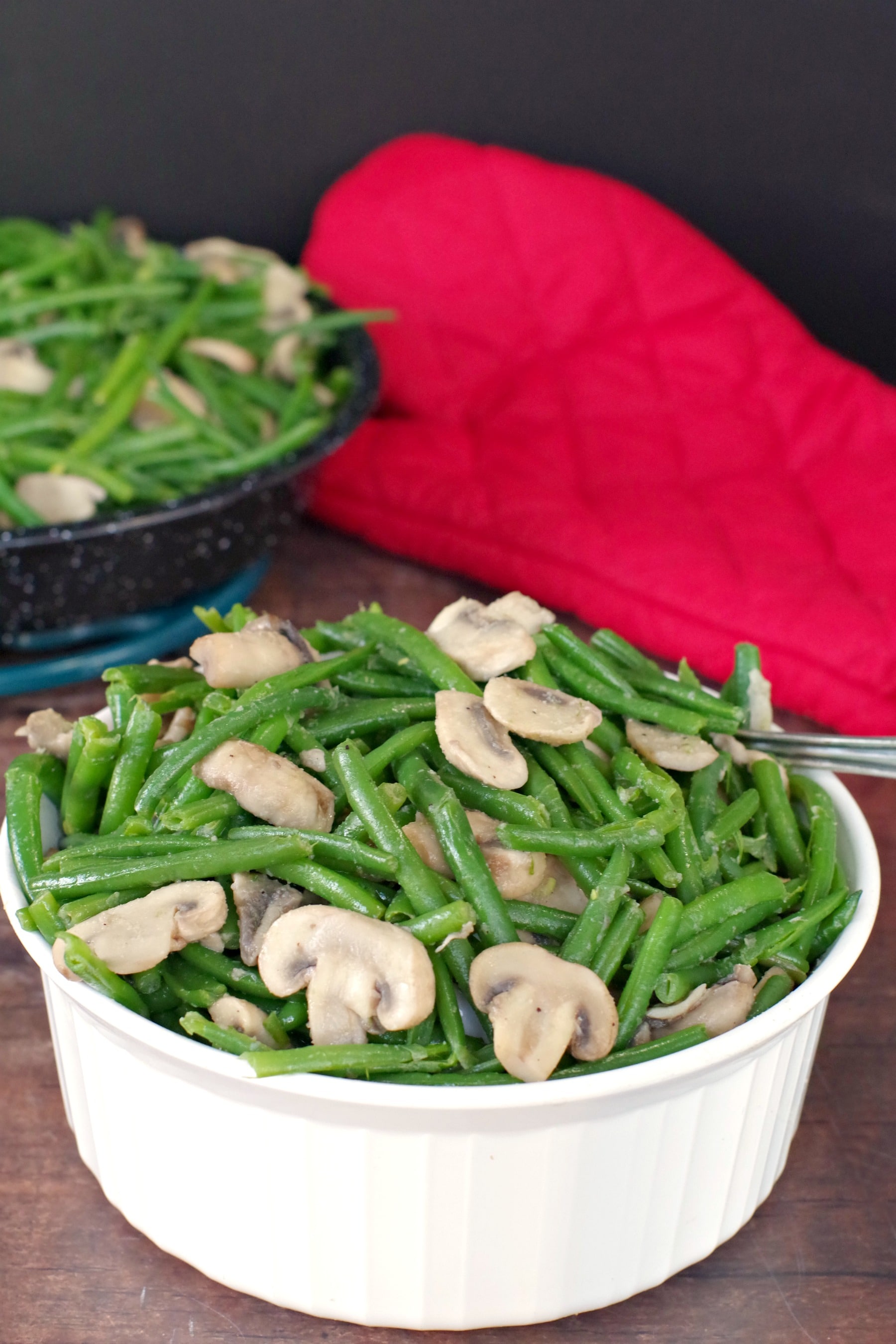 green beans and mushrooms in a white round casserole dish