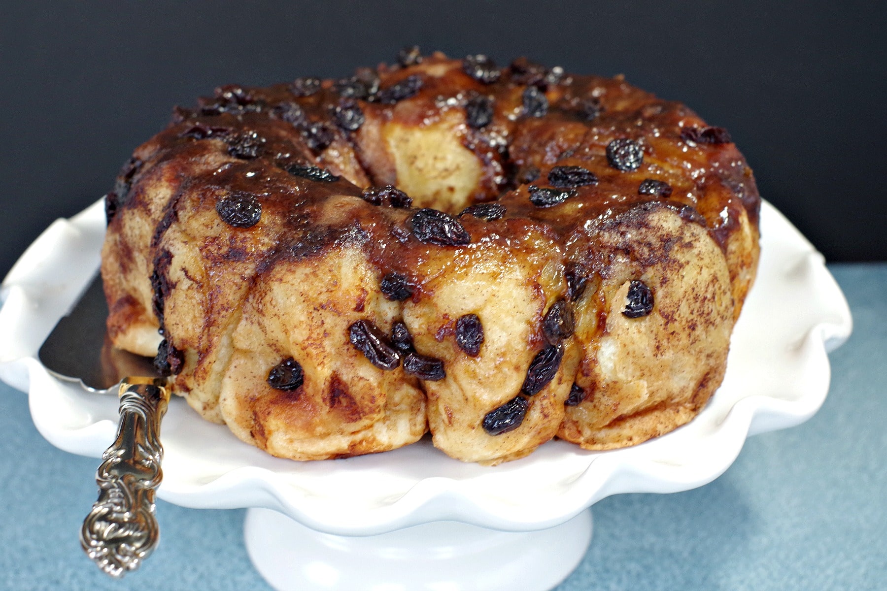 Overnight Cinnamon Sticky Buns on a white cake platter