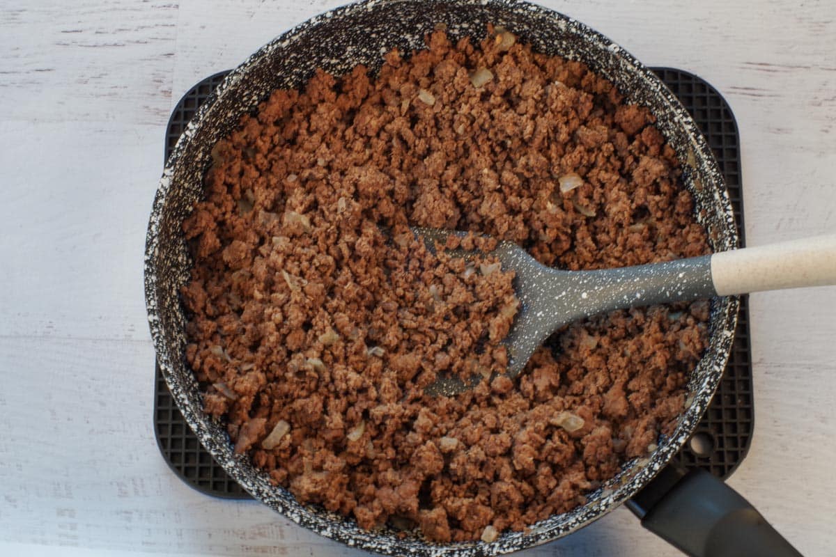 cooked ground beef in frying pan with spatula