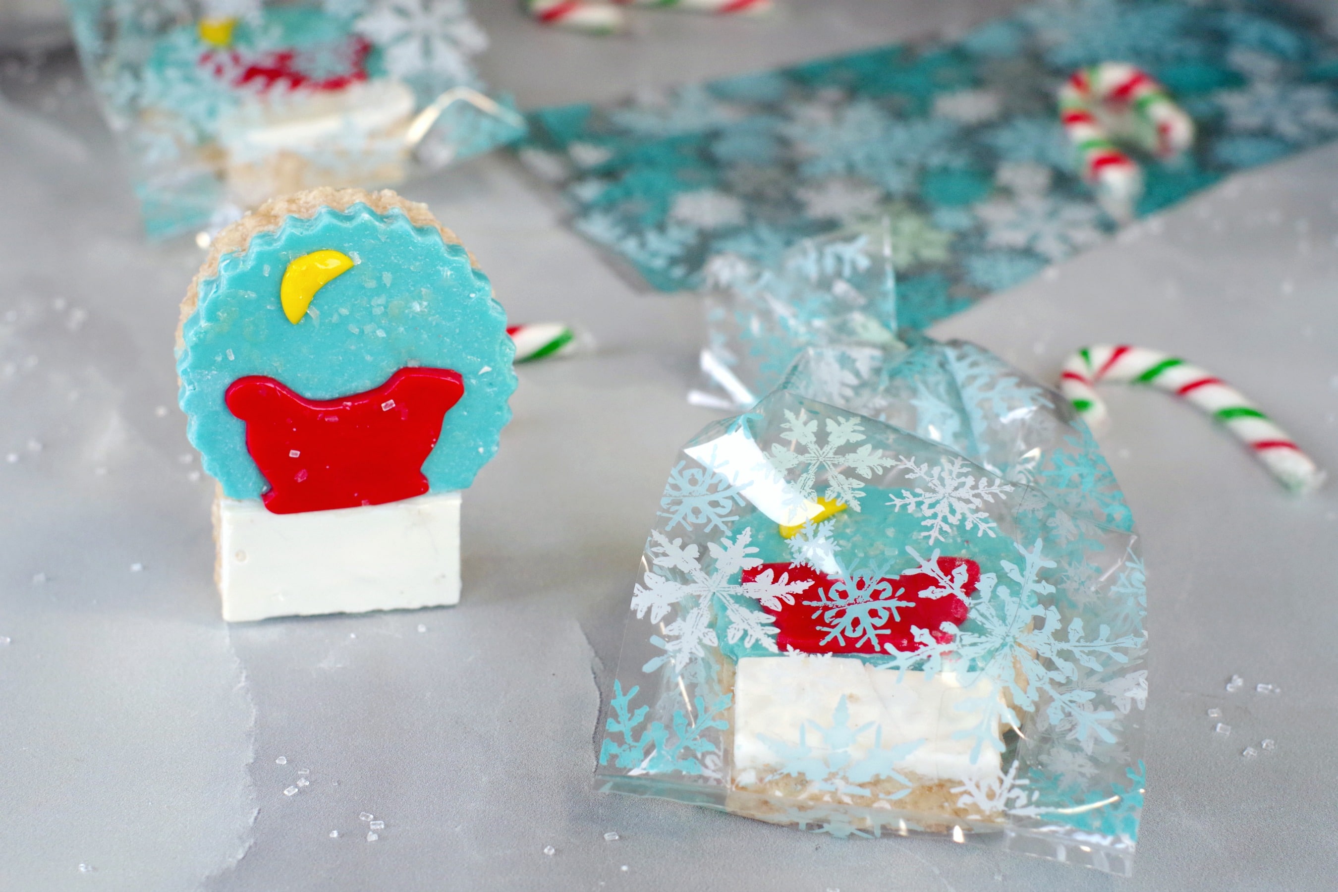 snow globe cereal treat with another in a clear snowflake package (with packaging in background)