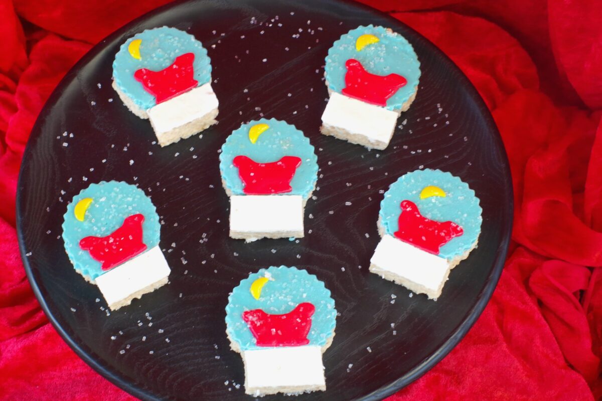 snow globe rice krispie treats on black tray