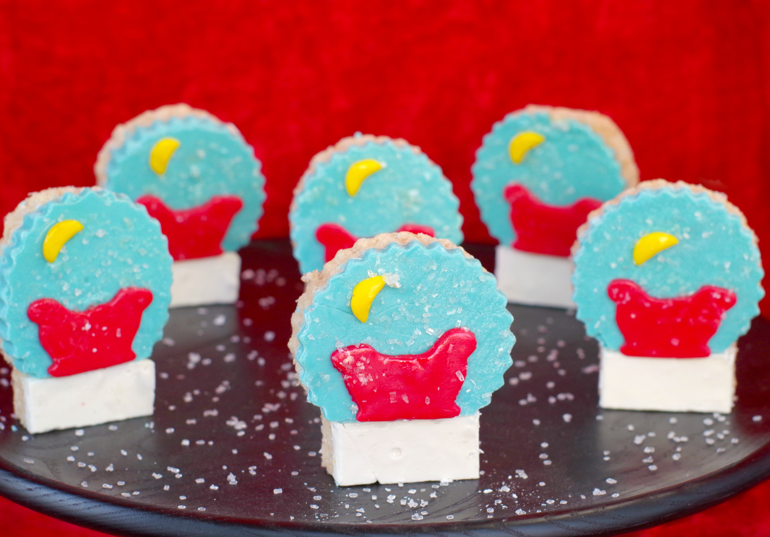 snow globe rice krispie treats on black tray