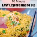Pinterest pin with text at the top and photo of nacho chip being dipped into layered nacho/taco dip