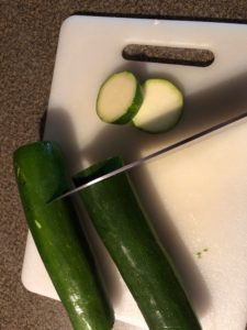 Zucchini being cut into circles