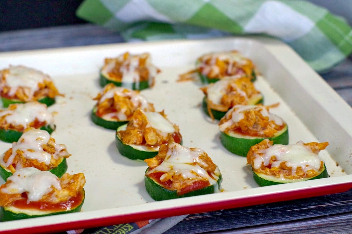 buffalo chicken zucchini pizza recipe on an off-white baking tray
