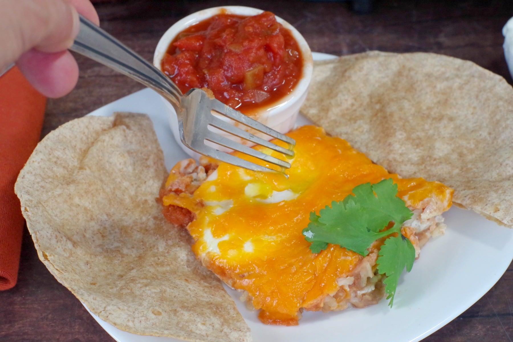 Sheet Pan Huevos Rancheros with fork poking egg