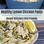 Creamy Lemon Chicken Pasta in a bowl with lemon wedges and blue ceramic pot in background