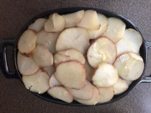 last layer of sliced potatoes on casserole