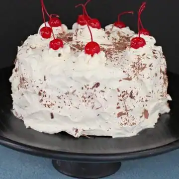whole black forest cake on black cake stand