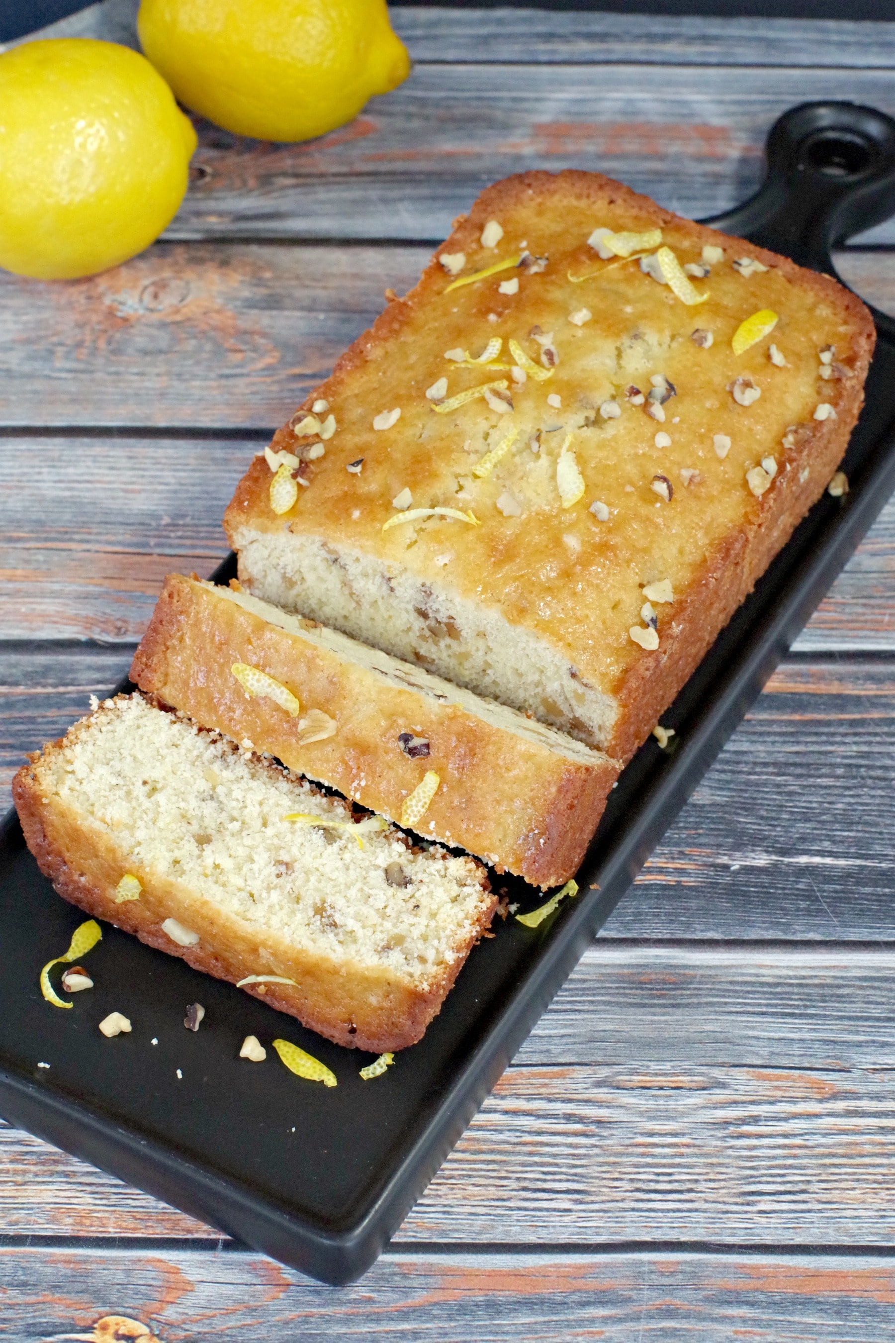 sliced lemon loaf on black tray