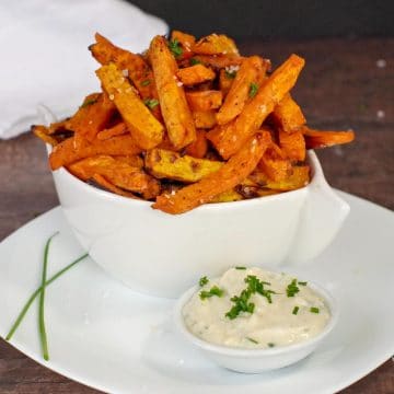 Sweet potato fries and dip in white plate on white bowl