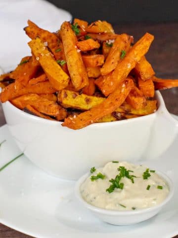 Sweet potato fries and dip in white plate on white bowl