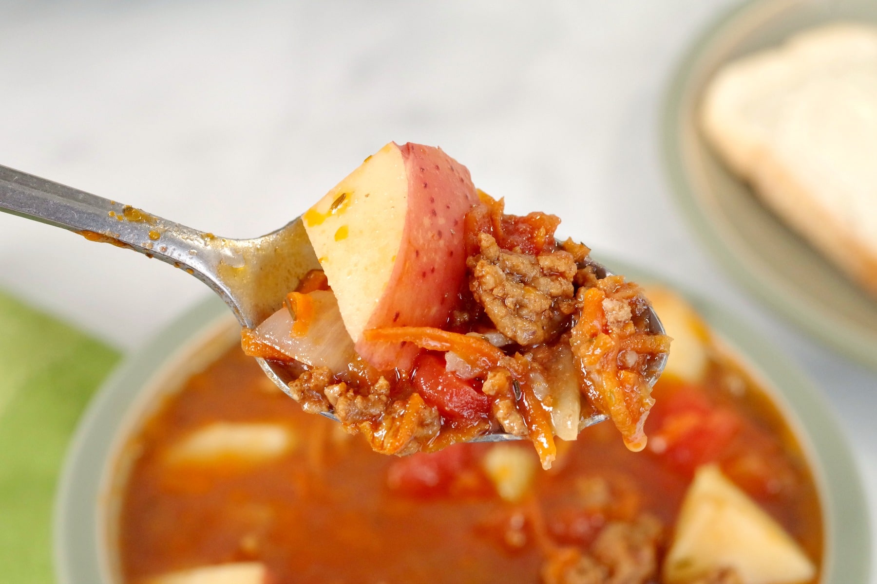 Hamburger soup being held on a spoon