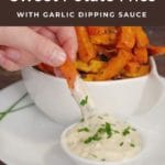 pin with text and photo of sweet potato fries being dipped into garlic mayo dip