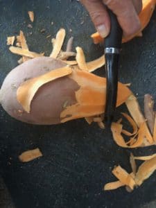 sweet potato being peeled