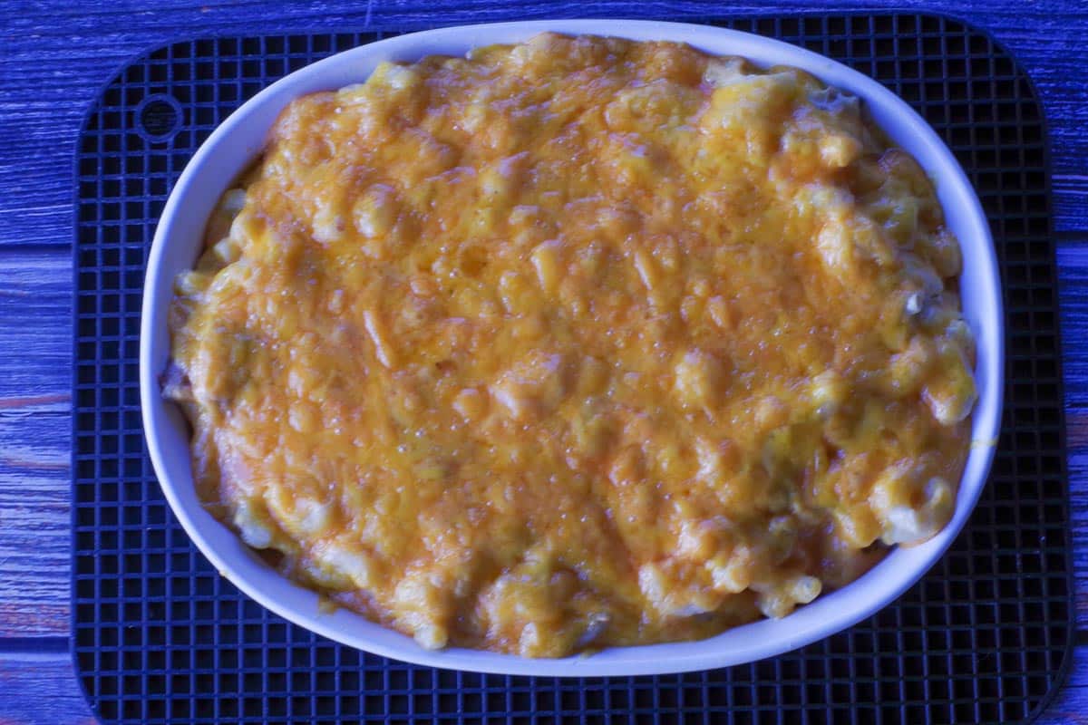 baked tuna casserole in white casserole dish on black trivet