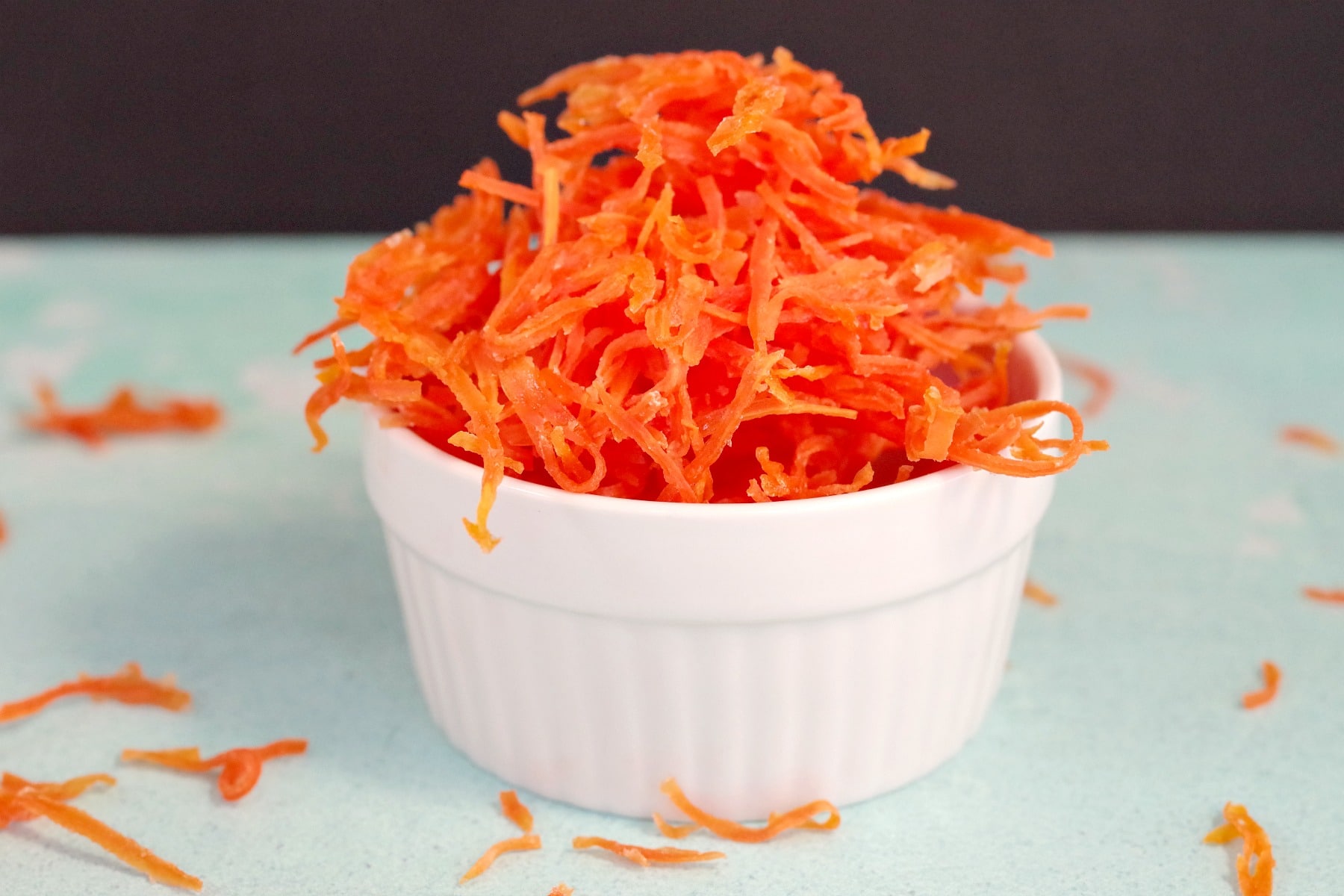Candied carrots in a small white dish 