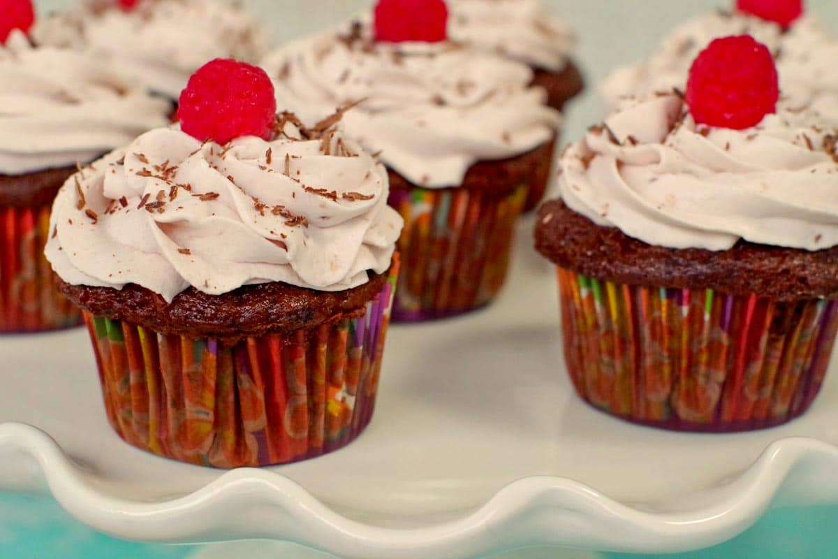 chocolate tiramisu cupcakes on a white cake platter