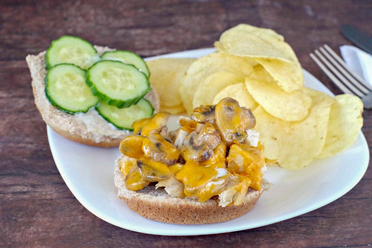healthy chicken burger on a plate, open-faced with potato chips on the side